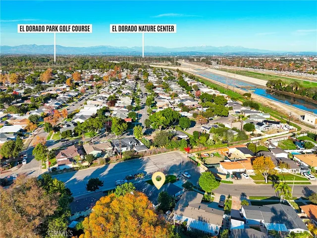 an aerial view of residential houses with outdoor space and street view