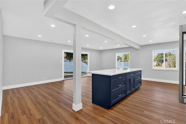 a kitchen with wooden floors and wooden cabinets