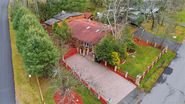 an aerial view of a house with a yard and trees