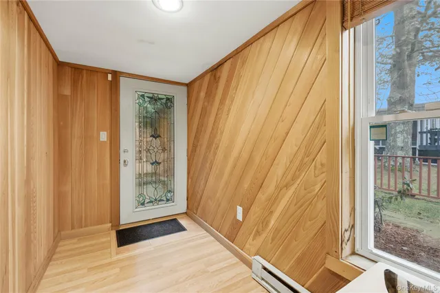 a view of wooden house with a large window