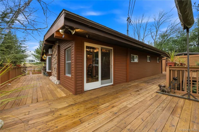 a view of backyard with wooden floor and fence