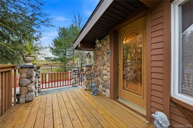 a view of a wooden deck with a yard