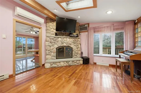 a living room with a fireplace and wooden floor