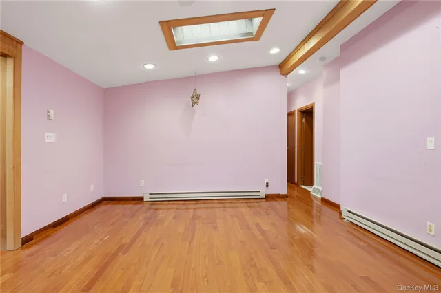 a view of a room with wooden floor