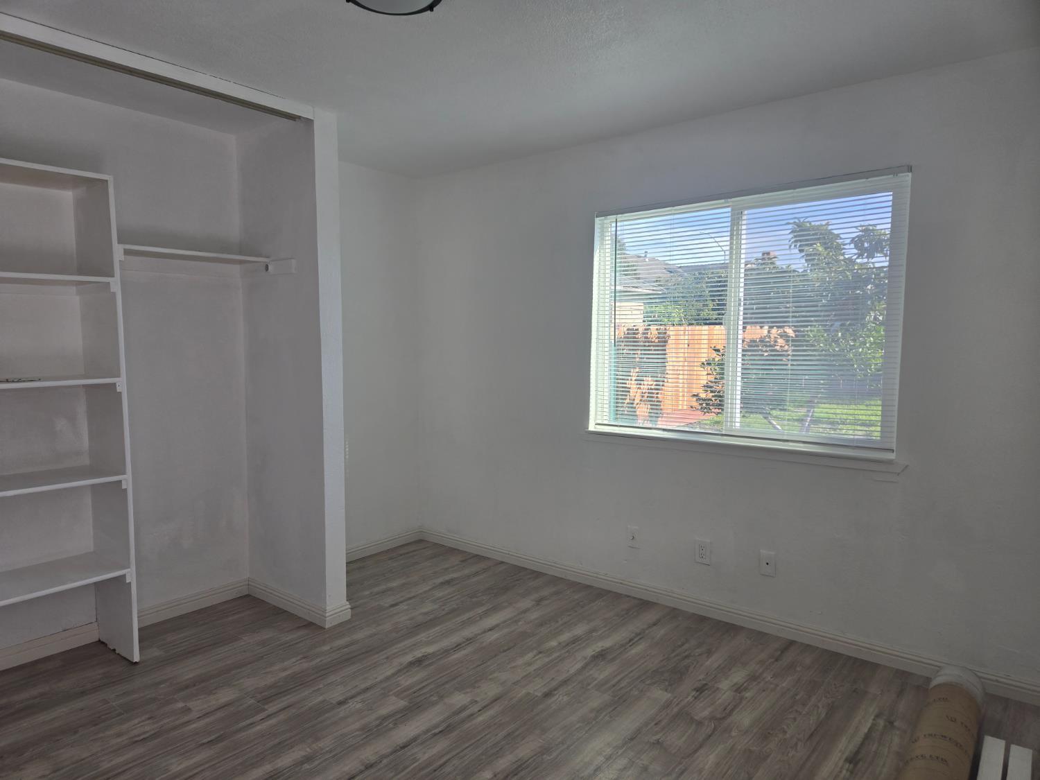 320 North Sanborn Road Salinas, CA 93905 - Photo 20 of 26 an empty room with wooden floor and windows