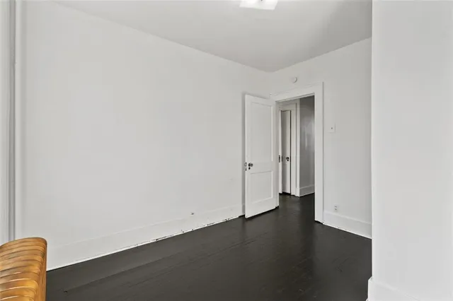 an empty room with wooden floor