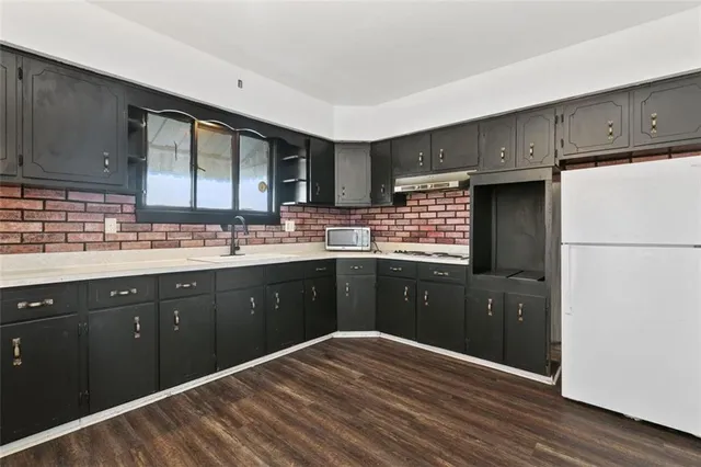 a kitchen with a refrigerator stove and sink