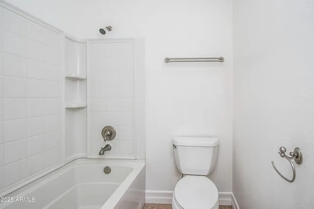 a bathroom with a toilet and a bathtub