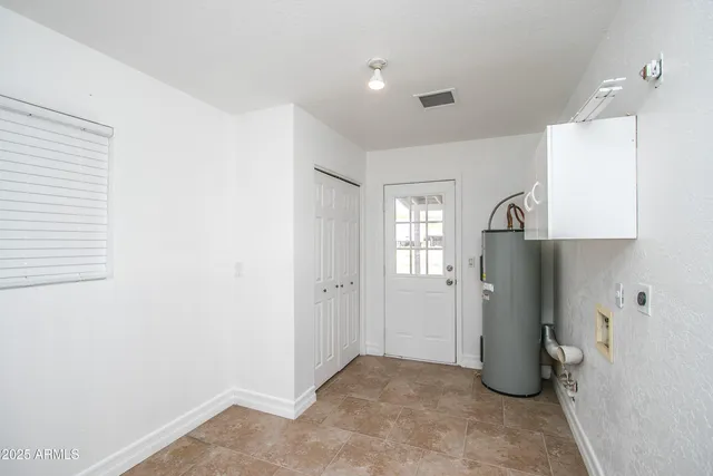 a view of a kitchen with refrigerator and window