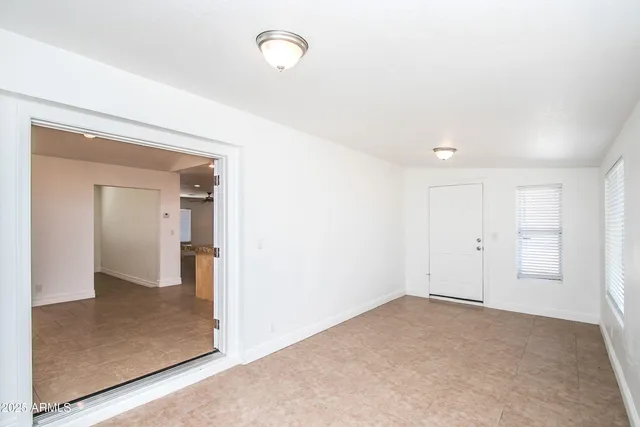 an empty room with mirror in it