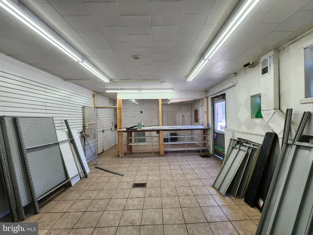 a view of kitchen with furniture and refrigerator
