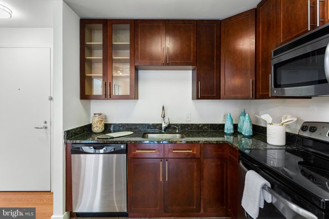 a kitchen with refrigerator and cabinets