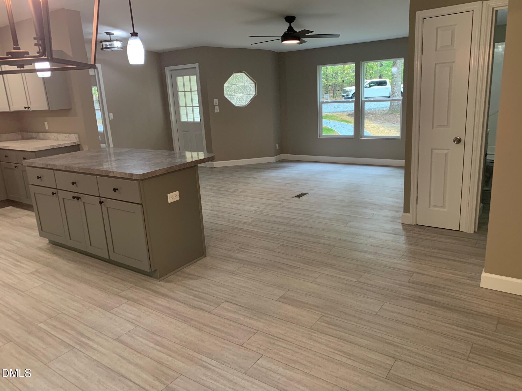 204 Deep Woods Trail Roxboro, NC 27574 - Photo 11 of 28 a view of a kitchen counter space and wooden floor