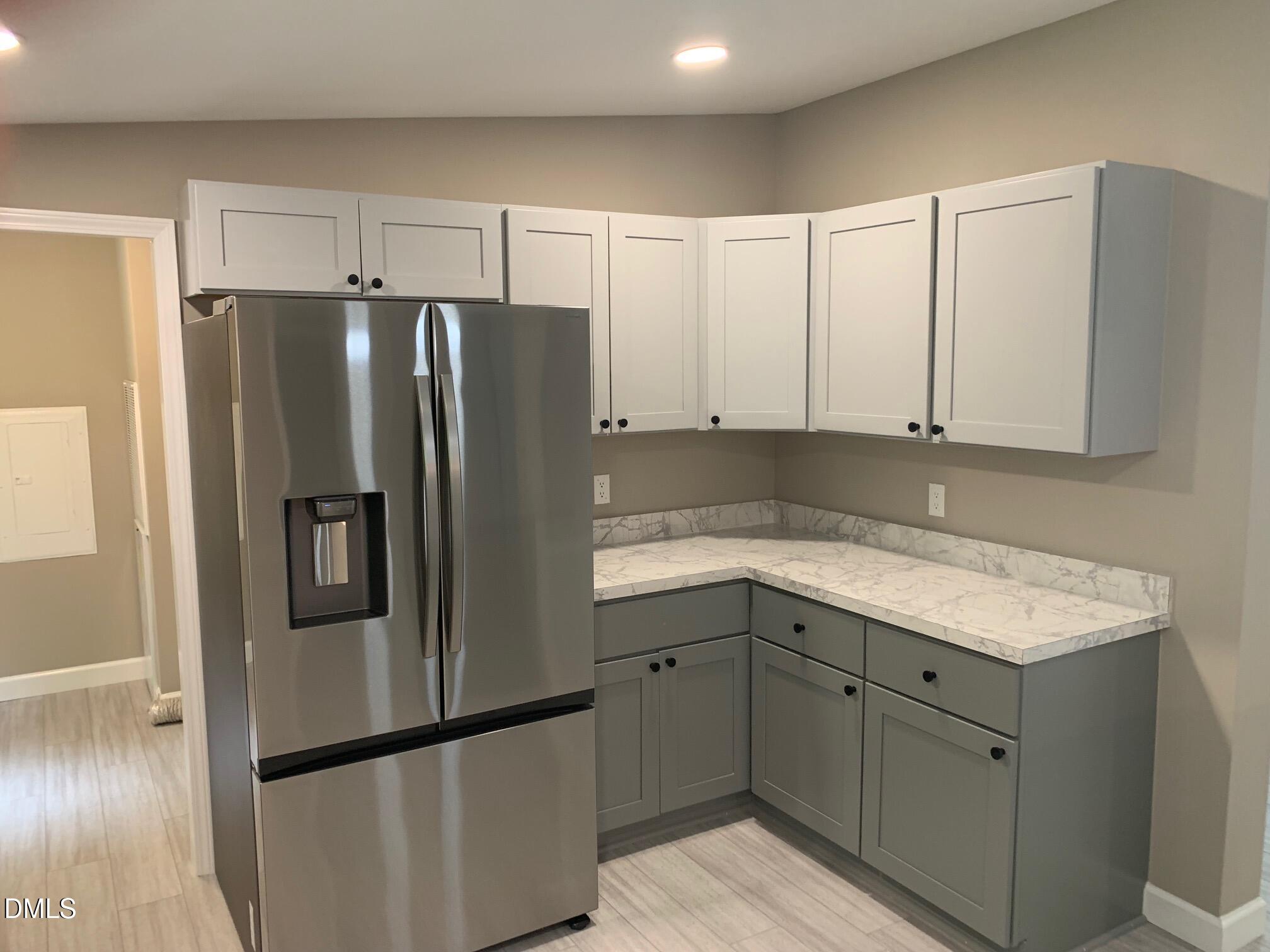 204 Deep Woods Trail Roxboro, NC 27574 - Photo 13 of 28 a kitchen with granite countertop white cabinets and stainless steel appliances