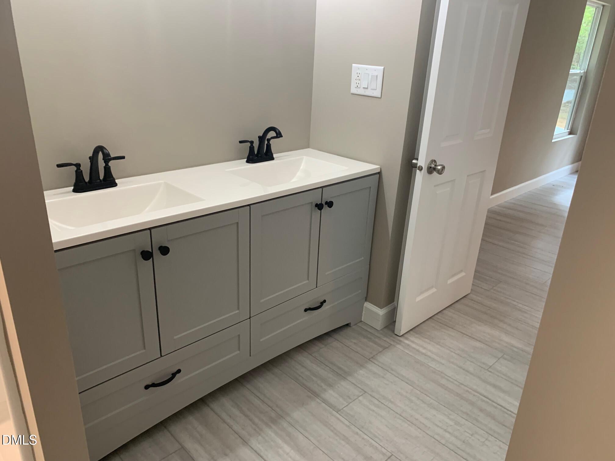 204 Deep Woods Trail Roxboro, NC 27574 - Photo 16 of 28 a bathroom with a sink and mirror