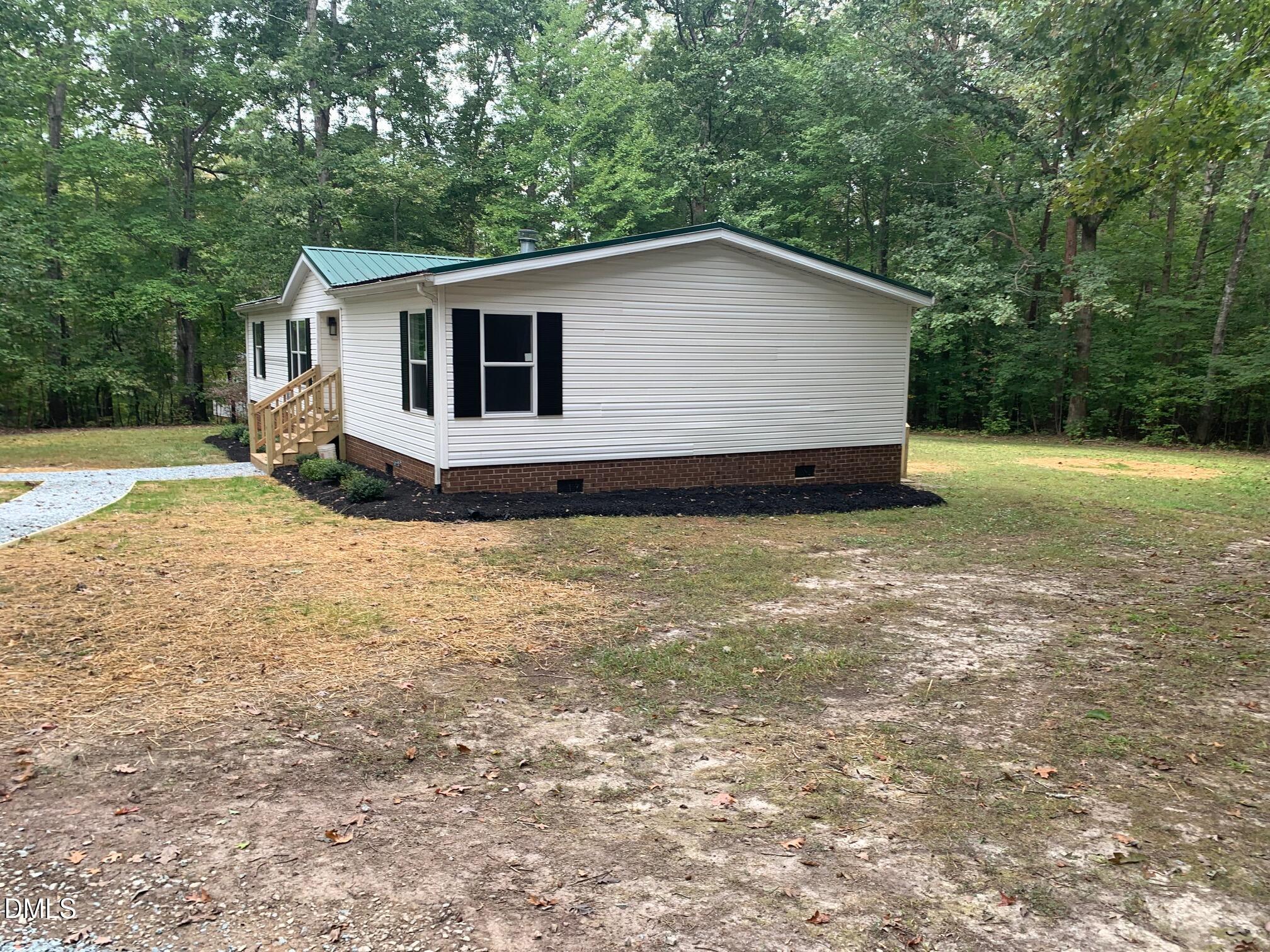 204 Deep Woods Trail Roxboro, NC 27574 - Photo 2 of 28 a view of a house with backyard