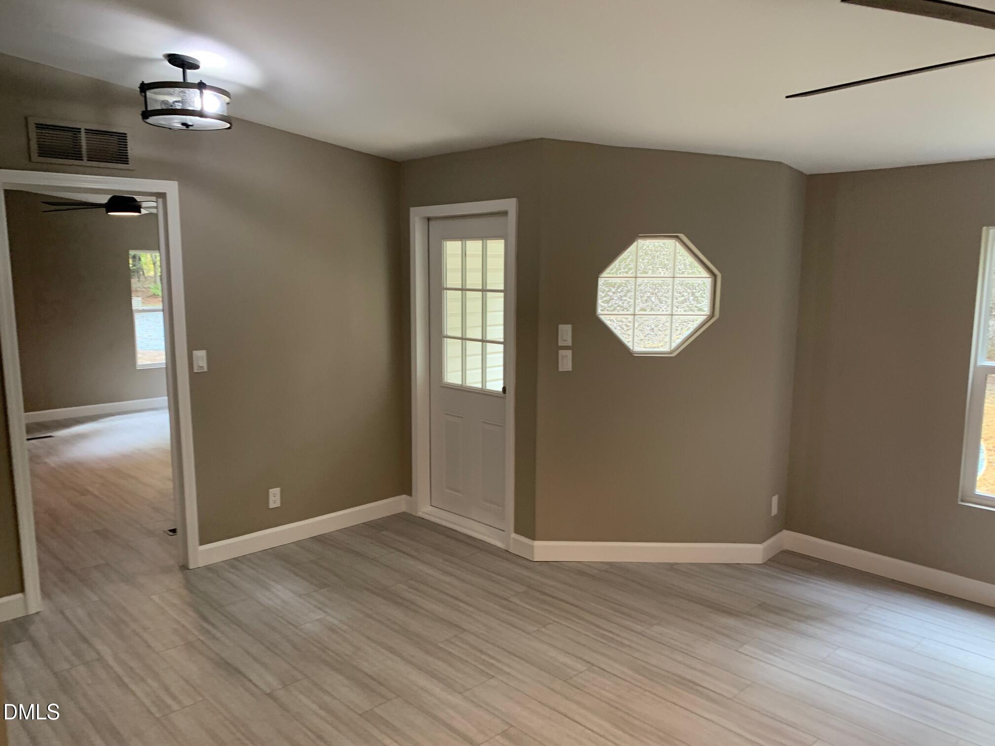 204 Deep Woods Trail Roxboro, NC 27574 - Photo 24 of 28 an empty room with wooden floor and windows
