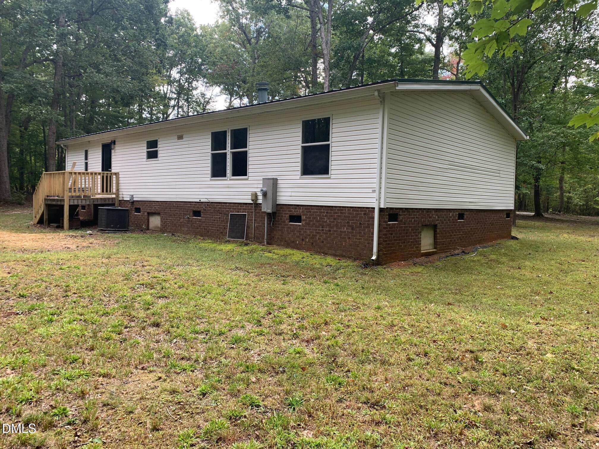 204 Deep Woods Trail Roxboro, NC 27574 - Photo 5 of 28 a backyard of a house with table and chairs