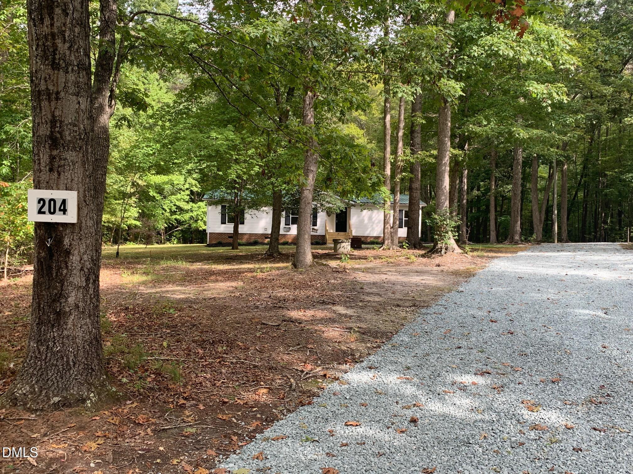 204 Deep Woods Trail Roxboro, NC 27574 - Photo 6 of 28 a backyard of a house with lots of green space
