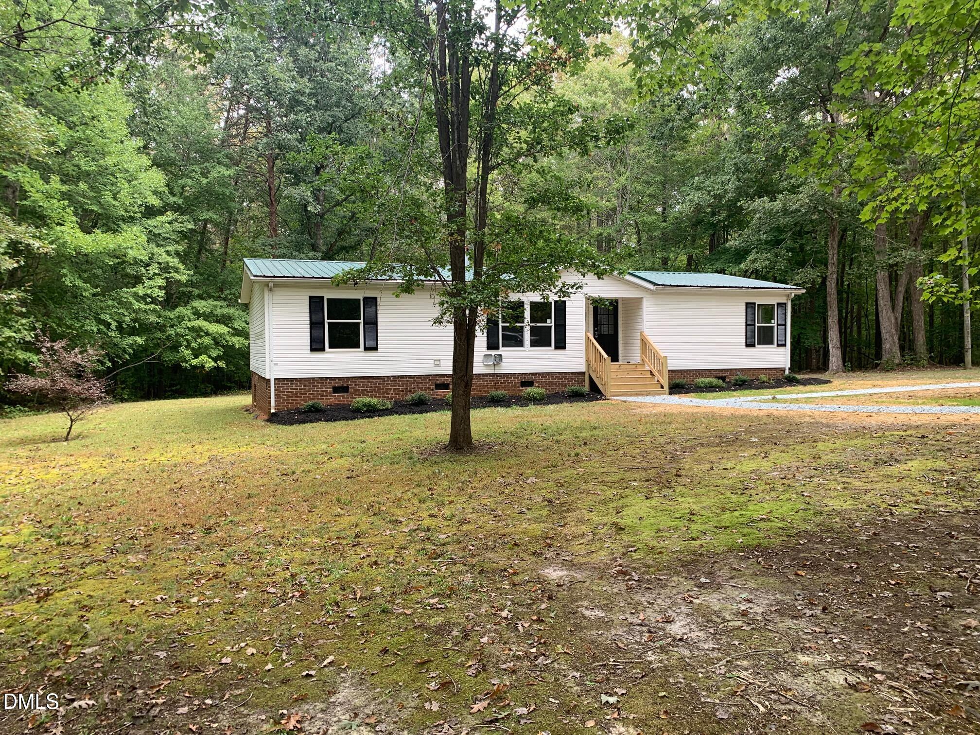 204 Deep Woods Trail Roxboro, NC 27574 - Photo 8 of 28 a front view of a house with garden