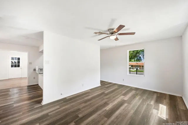 wooden floor in an empty room with a window