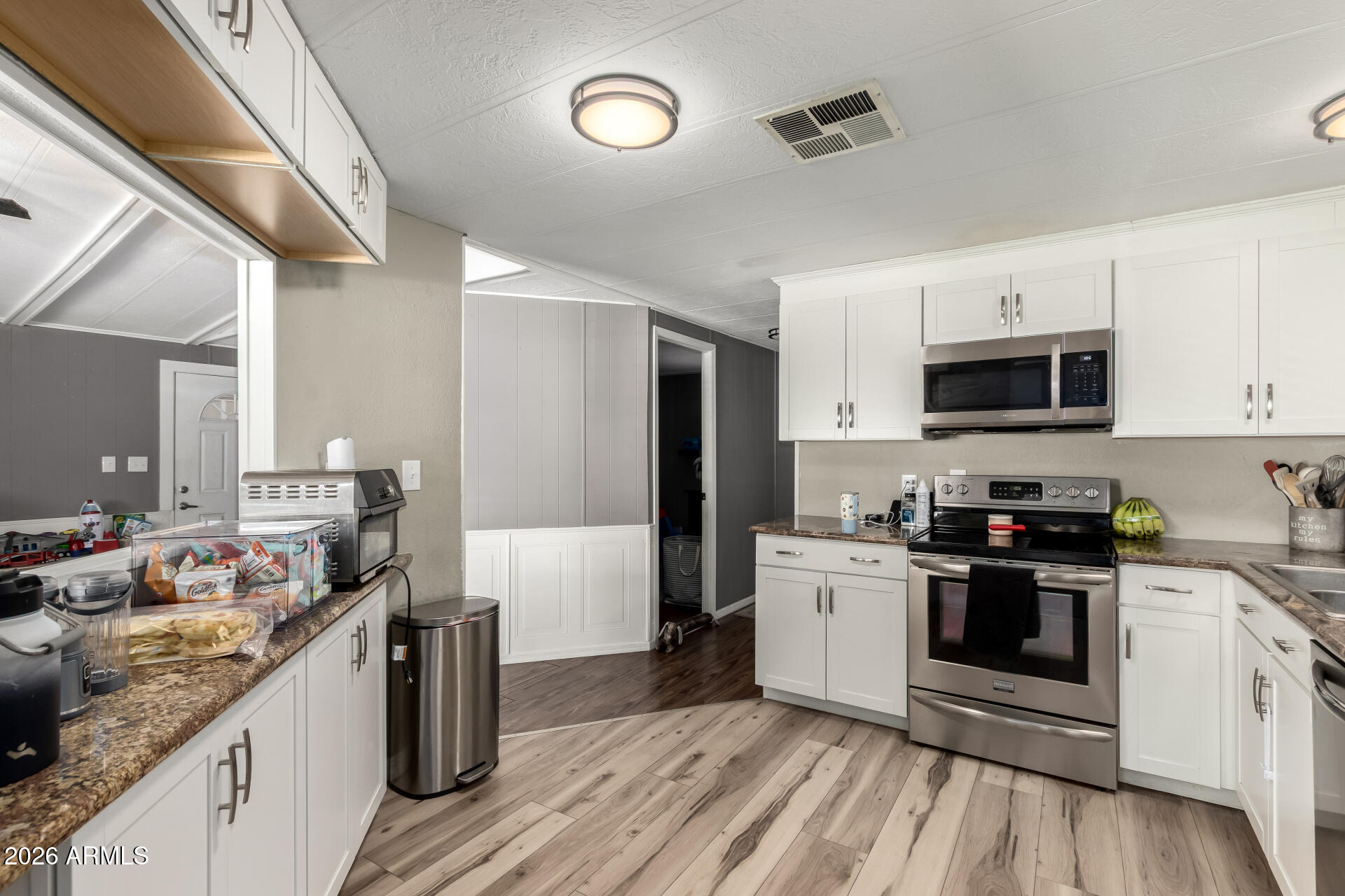 245 South 56th Street, Unit 64 Mesa, AZ 85206 - Photo 13 of 35 a kitchen with a stove and a sink