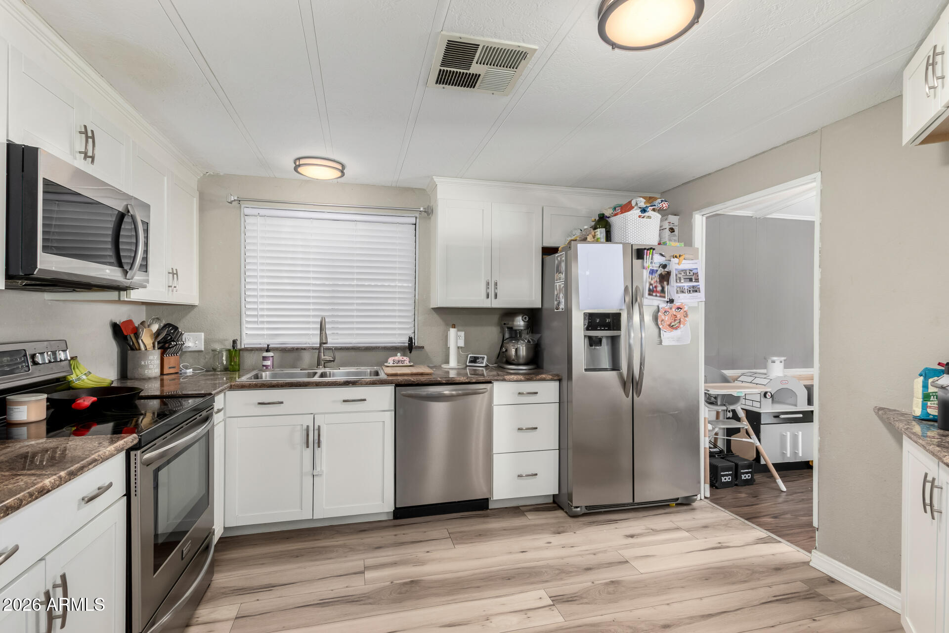 245 South 56th Street, Unit 64 Mesa, AZ 85206 - Photo 14 of 35 a kitchen with granite countertop a refrigerator stove top oven and sink