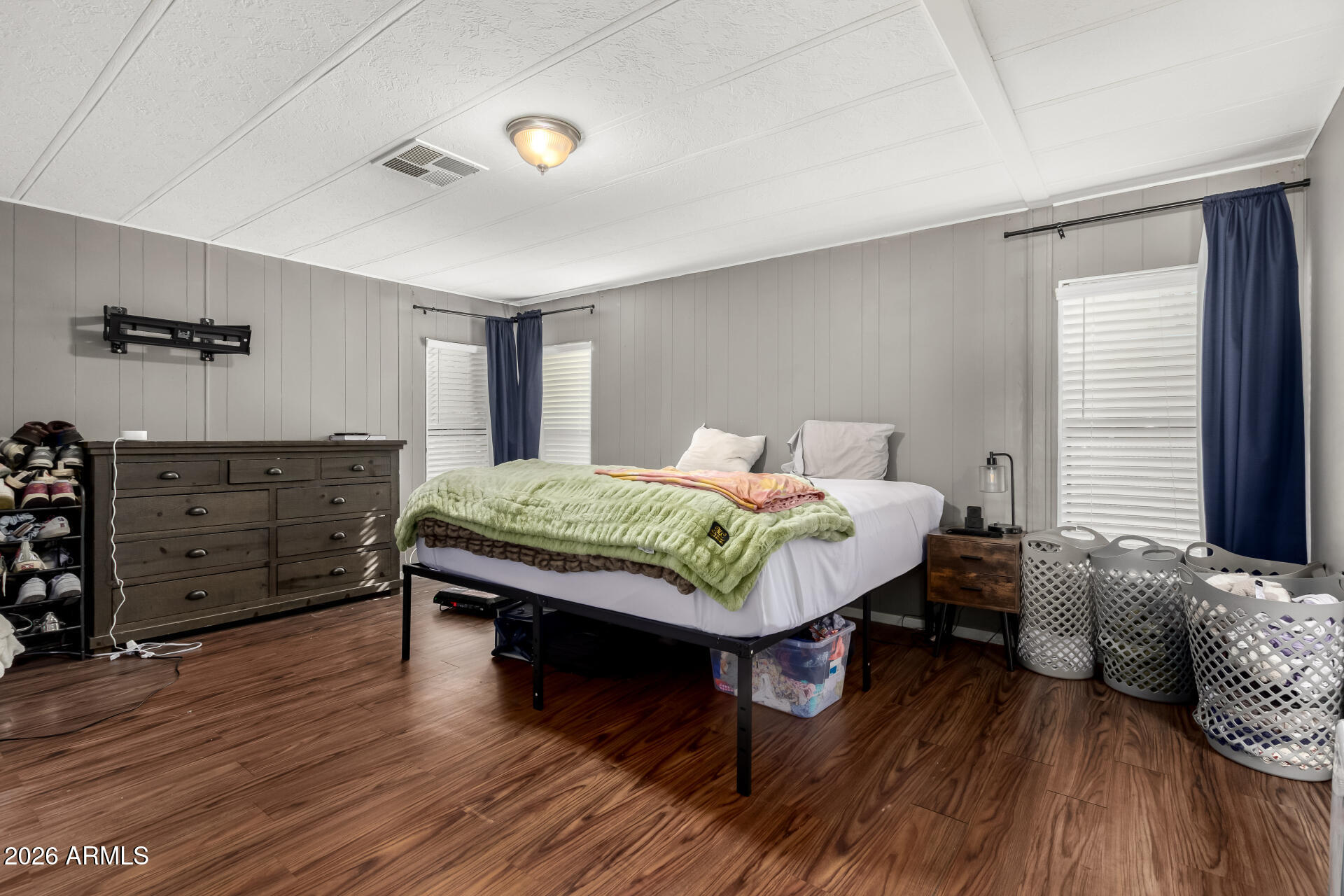 245 South 56th Street, Unit 64 Mesa, AZ 85206 - Photo 15 of 35 a bedroom with a bed and wooden floor