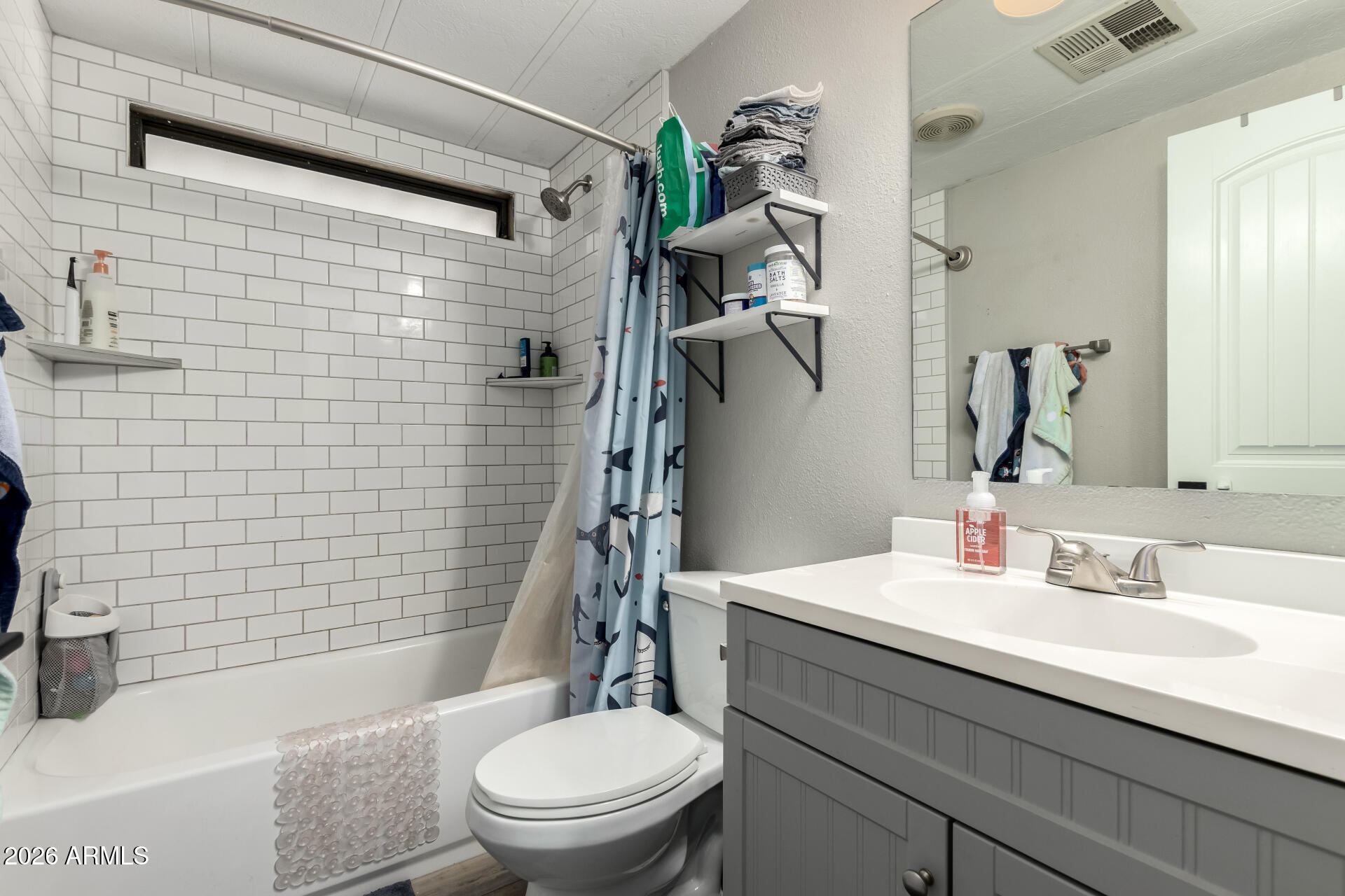 245 South 56th Street, Unit 64 Mesa, AZ 85206 - Photo 22 of 34 a bathroom with a sink a toilet and shower