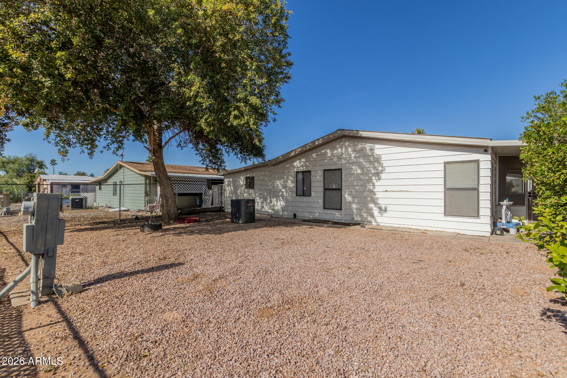 245 South 56th Street, Unit 64 Mesa, AZ 85206 - Photo 29 of 34 a front view of a house with a yard and garage