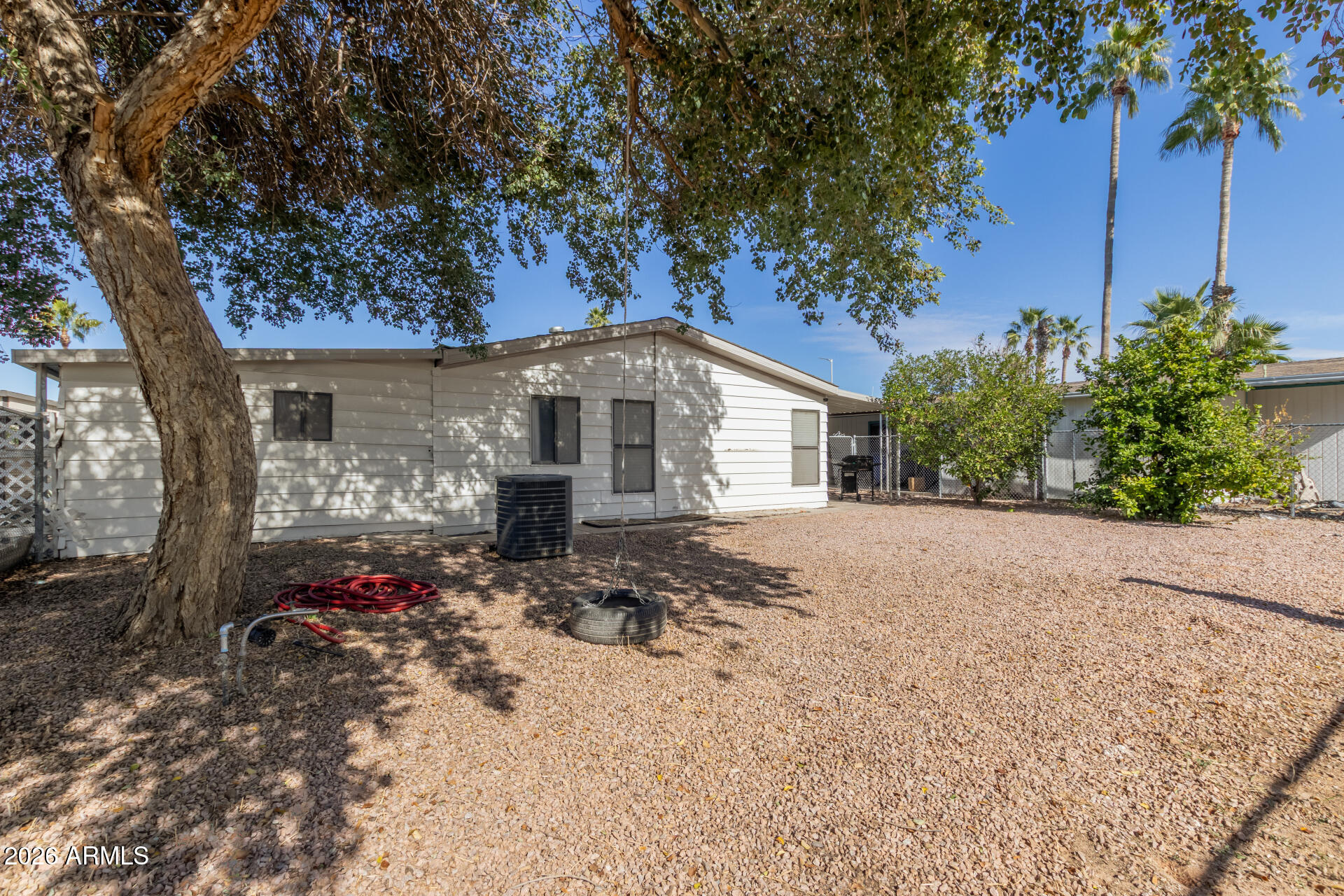245 South 56th Street, Unit 64 Mesa, AZ 85206 - Photo 30 of 34 a front view of a house with a yard and a garage