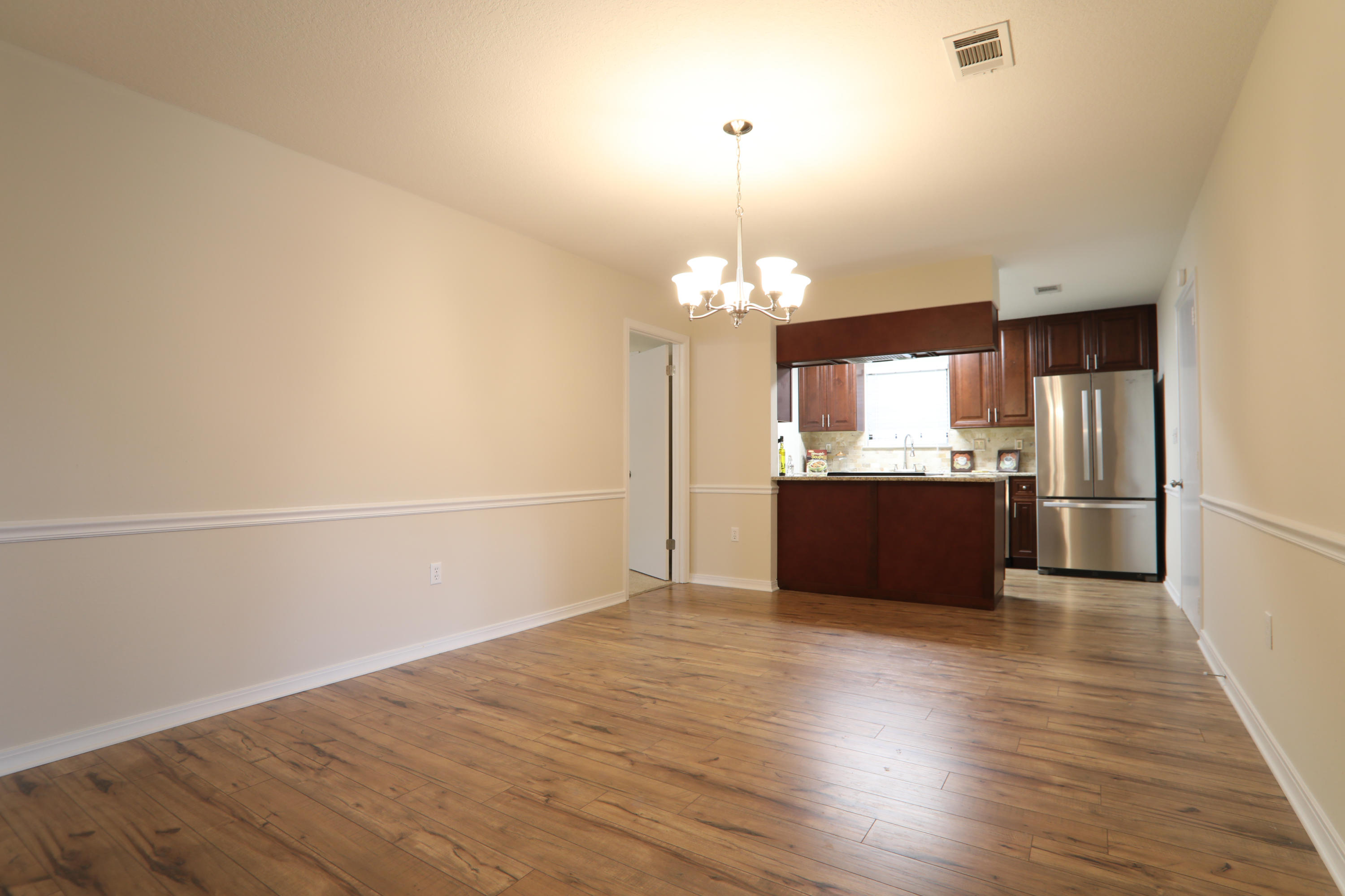 102 Brian Drive Crestview, FL 32536 - Photo 12 of 21 a view of a kitchen with a sink and dishwasher a refrigerator with wooden floor