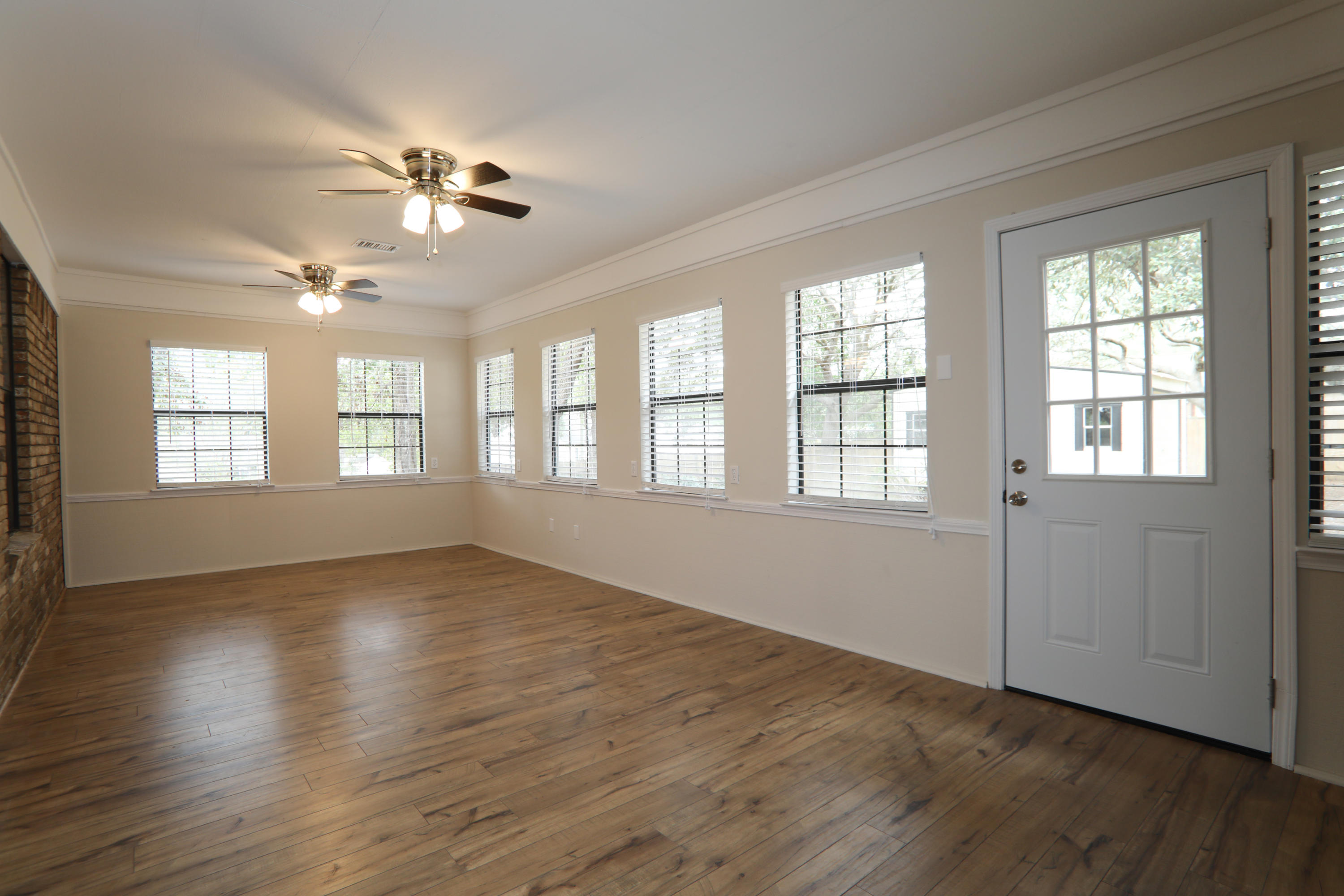 102 Brian Drive Crestview, FL 32536 - Photo 13 of 21 a view of an empty room with wooden floor and a window