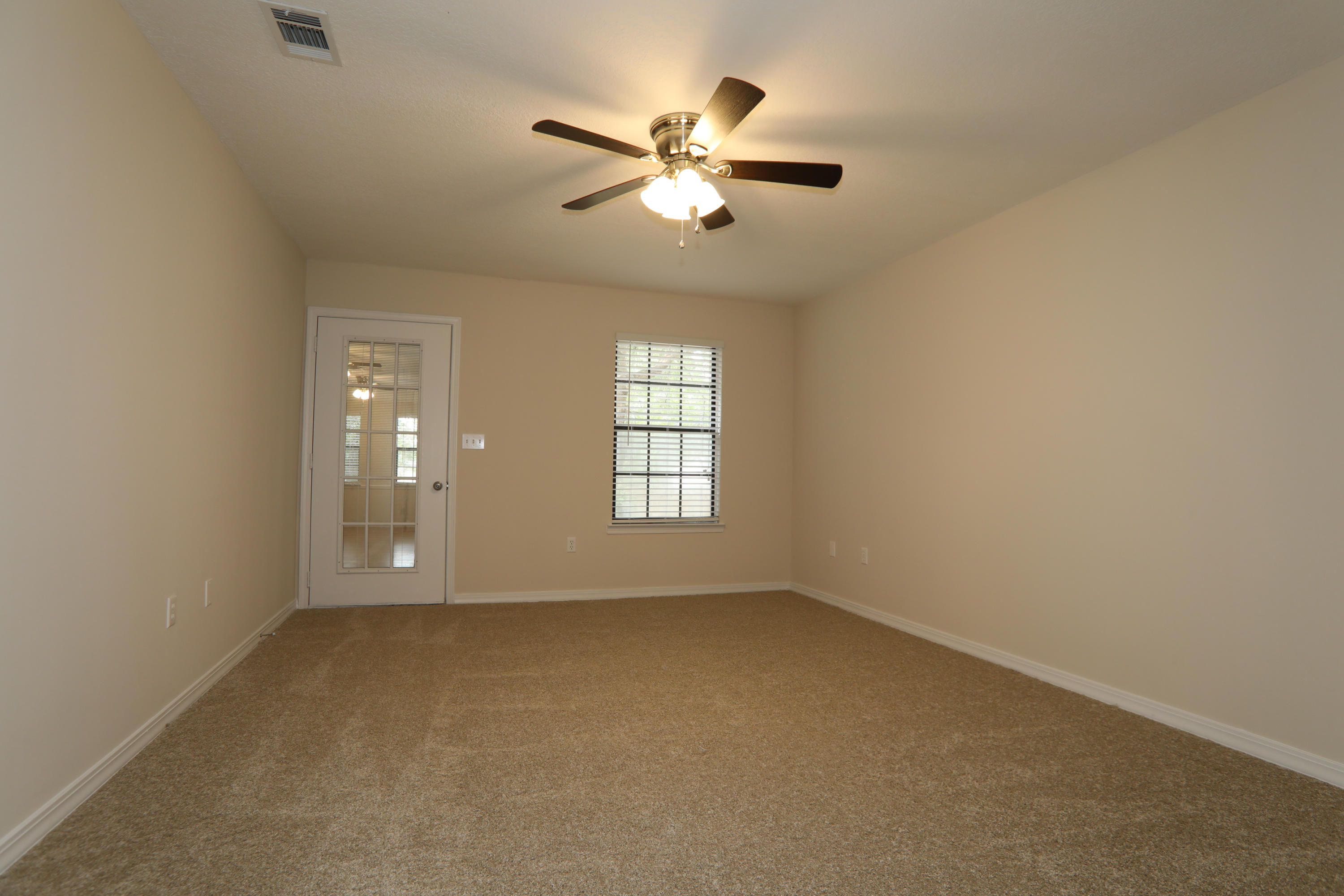 102 Brian Drive Crestview, FL 32536 - Photo 15 of 21 an empty room with chandelier fan and windows