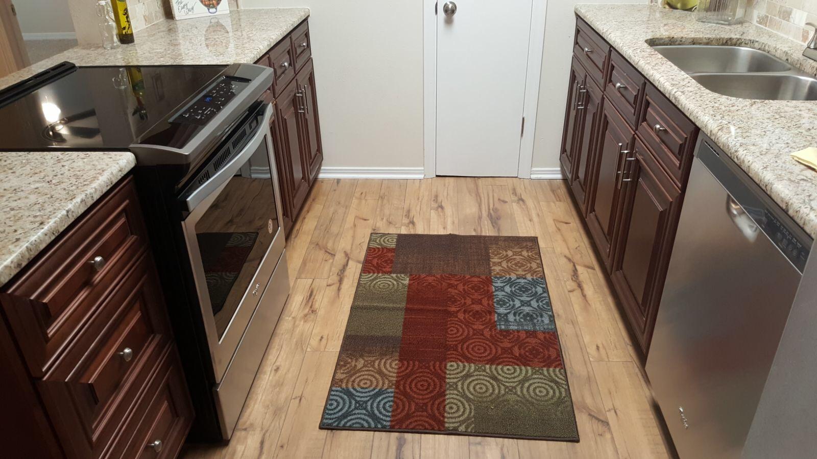 102 Brian Drive Crestview, FL 32536 - Photo 2 of 21 a kitchen with a granite countertop sink and washing machine