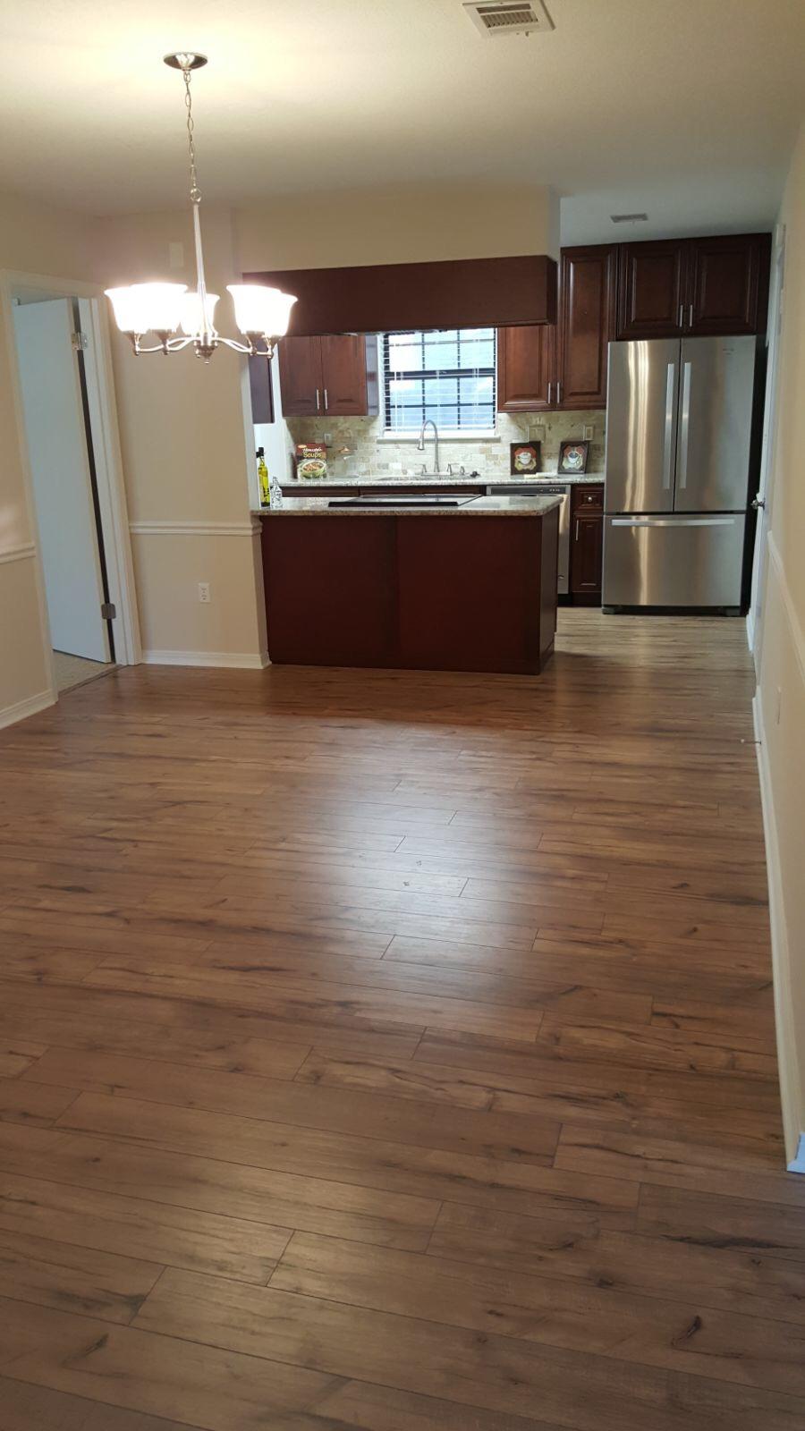102 Brian Drive Crestview, FL 32536 - Photo 4 of 21 a kitchen with kitchen island a sink wooden floor and a counter top space
