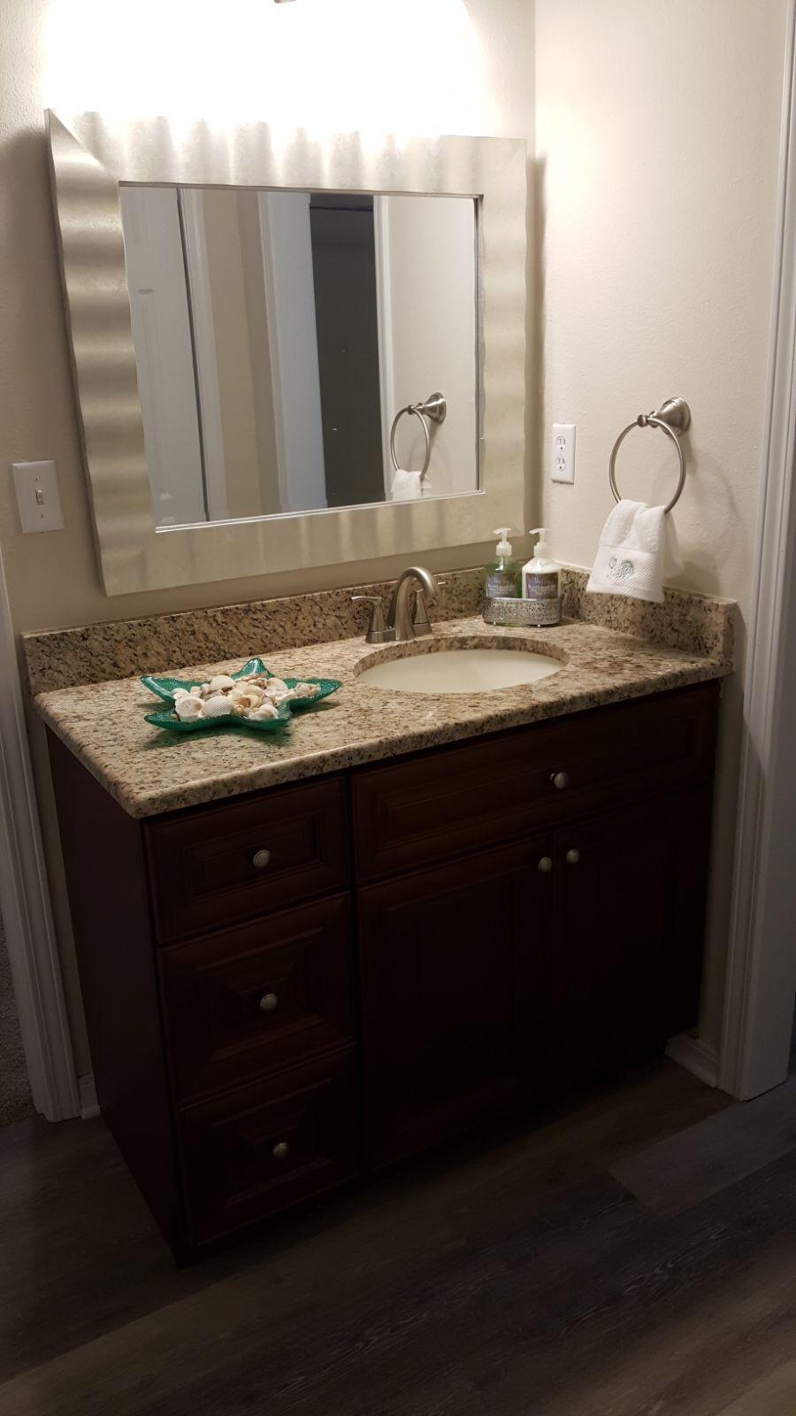 102 Brian Drive Crestview, FL 32536 - Photo 6 of 21 a bathroom with a granite countertop sink and a mirror