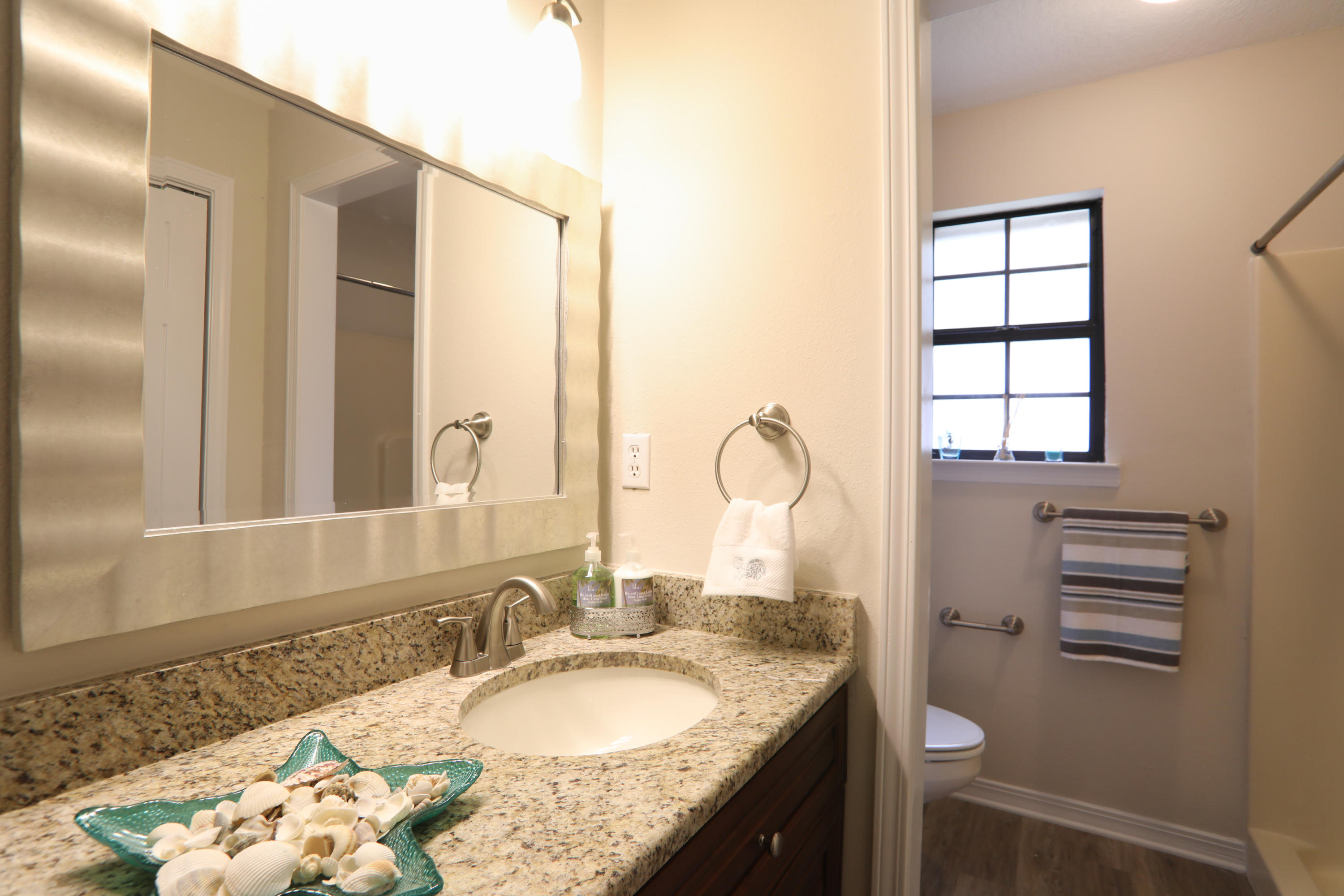 102 Brian Drive Crestview, FL 32536 - Photo 7 of 21 a bathroom with a granite countertop sink and a mirror