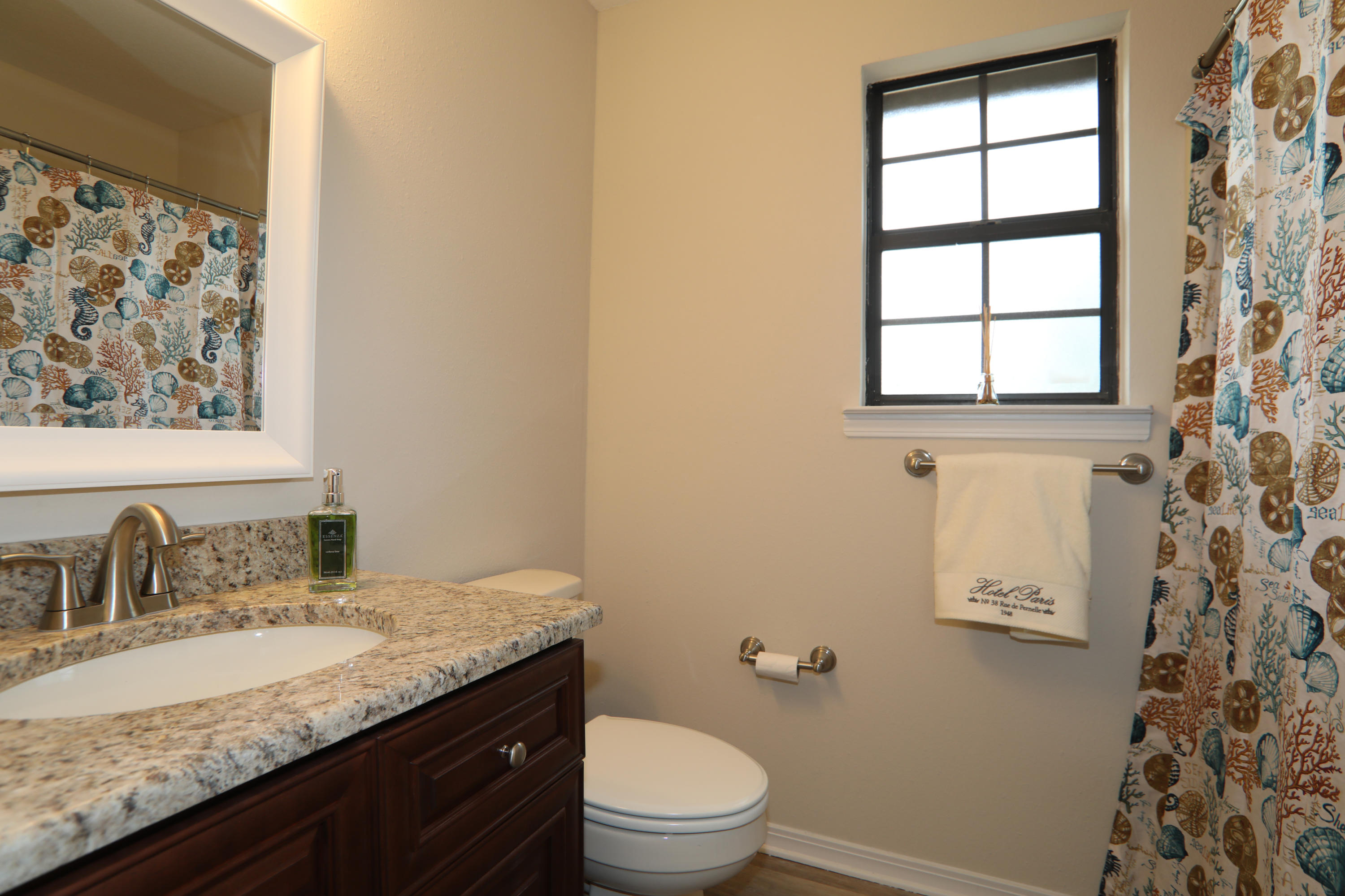 102 Brian Drive Crestview, FL 32536 - Photo 8 of 21 a bathroom with a granite countertop sink toilet and mirror