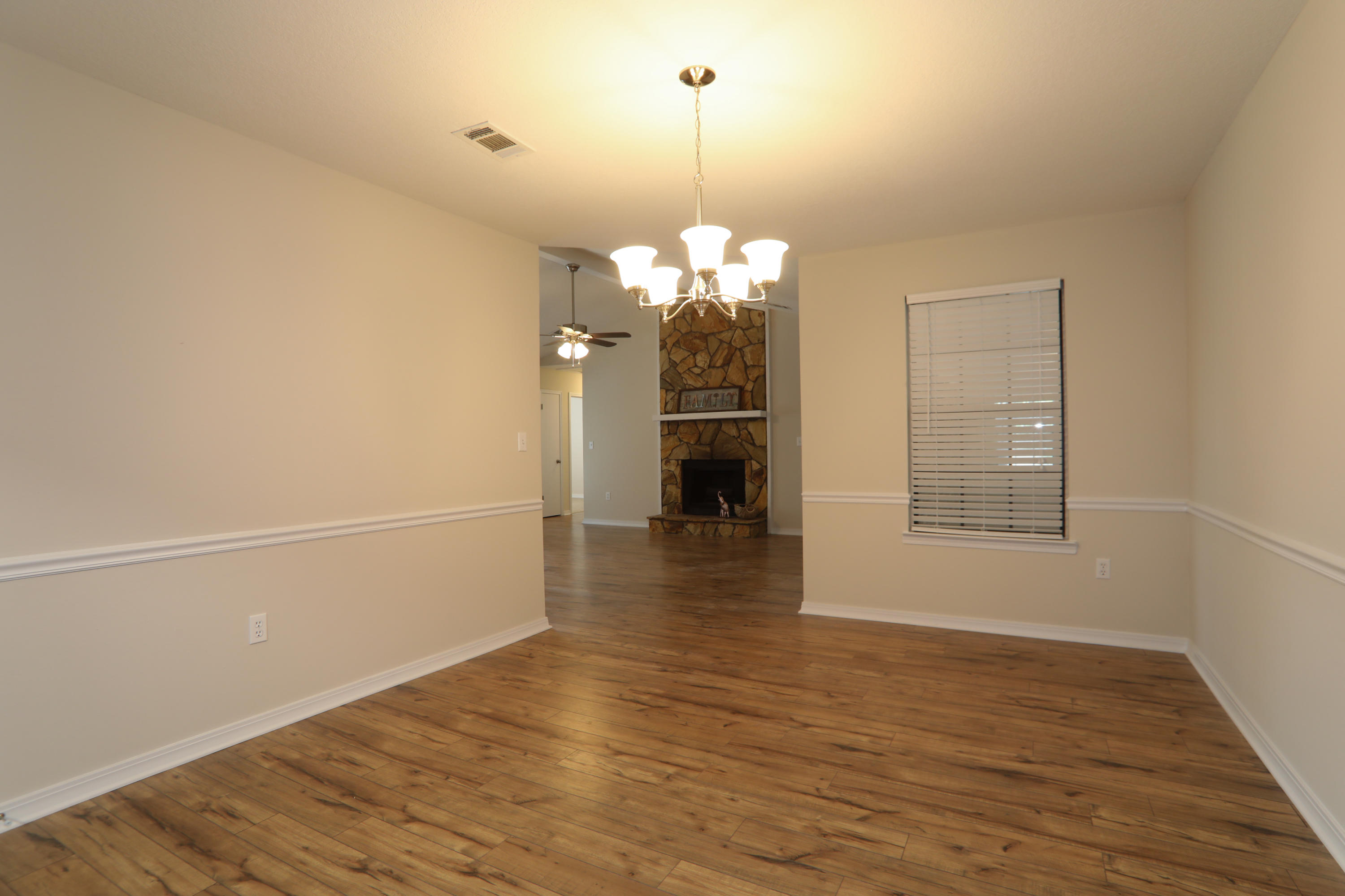 102 Brian Drive Crestview, FL 32536 - Photo 9 of 21 a view of a room with wooden floor and a window