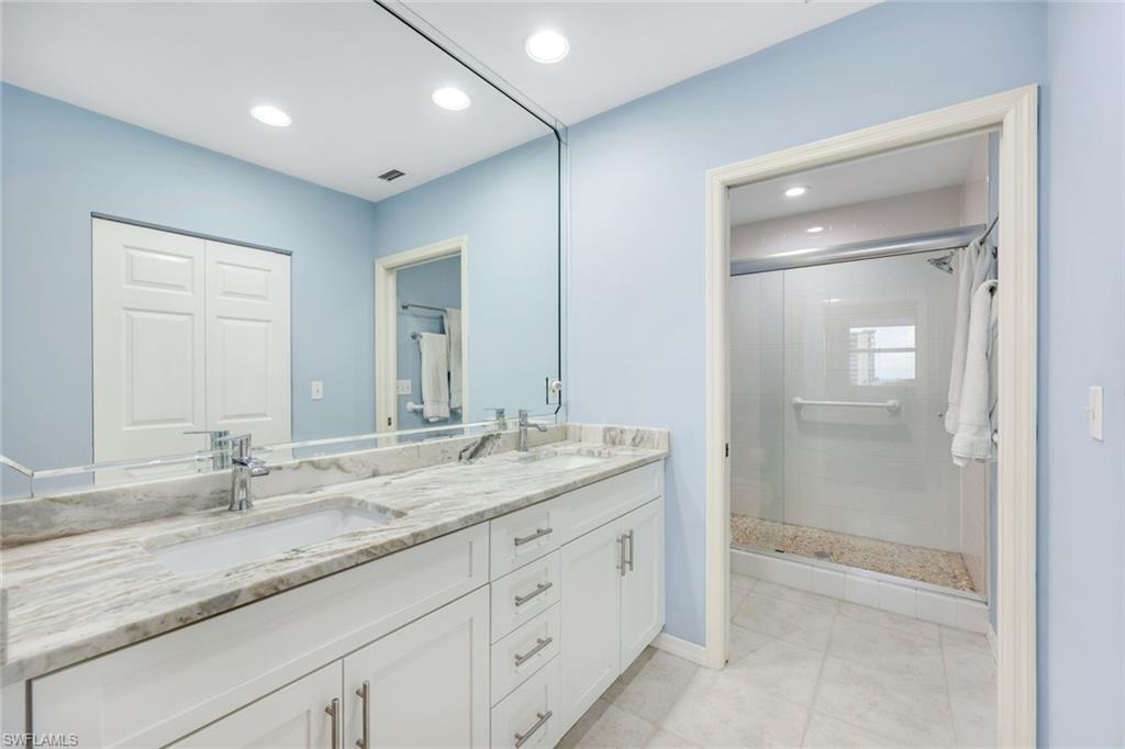 460 Launch Circle, Unit PH1 Naples, FL 34108 - Photo 11 of 28 a bathroom with a granite countertop sink shower and a mirror
