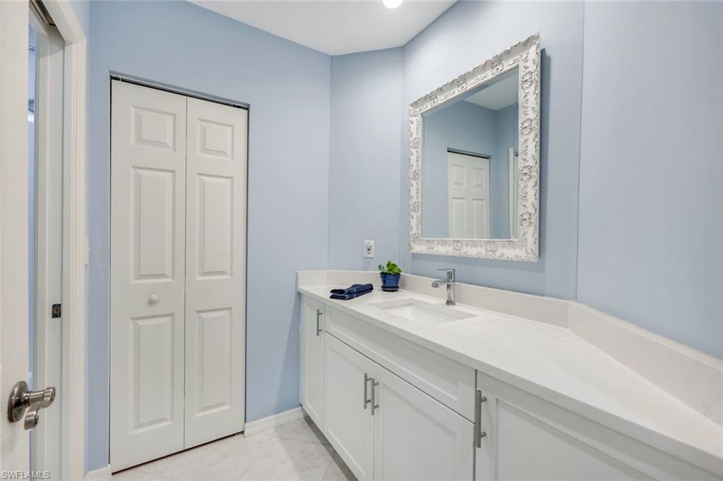 460 Launch Circle, Unit PH1 Naples, FL 34108 - Photo 13 of 28 a bathroom with a sink and a mirror