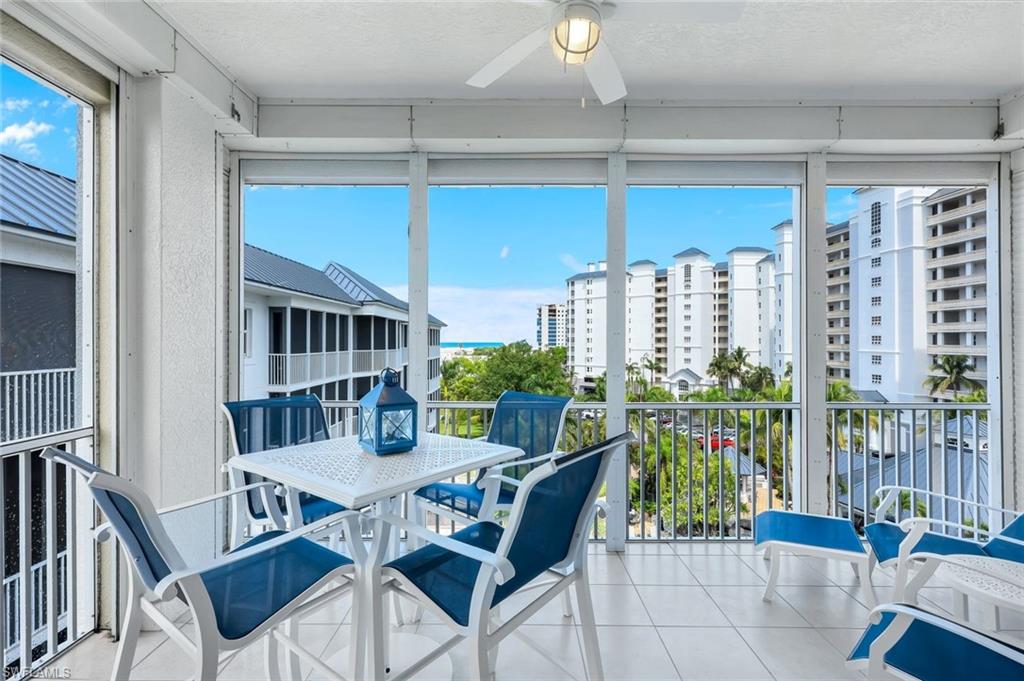 460 Launch Circle, Unit PH1 Naples, FL 34108 - Photo 14 of 28 a view of a dining room with furniture and window