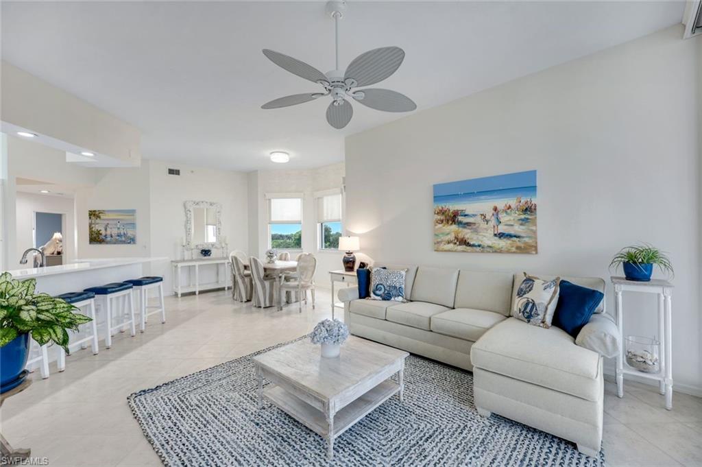 460 Launch Circle, Unit PH1 Naples, FL 34108 - Photo 2 of 28 a living room with furniture and a chandelier