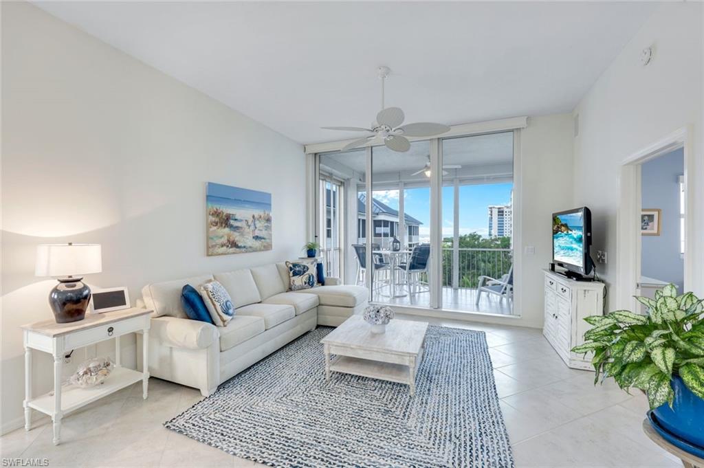 460 Launch Circle, Unit PH1 Naples, FL 34108 - Photo 3 of 28 a living room with furniture and a flat screen tv