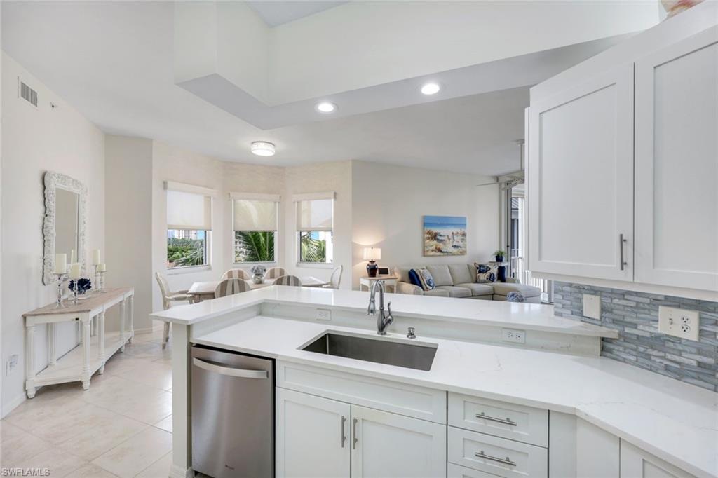 460 Launch Circle, Unit PH1 Naples, FL 34108 - Photo 5 of 28 a kitchen with sink and cabinets