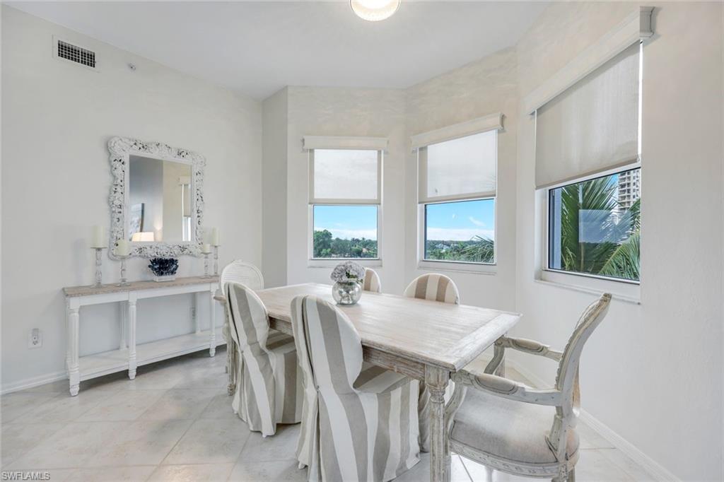 460 Launch Circle, Unit PH1 Naples, FL 34108 - Photo 7 of 28 a view of a dining room with furniture and window