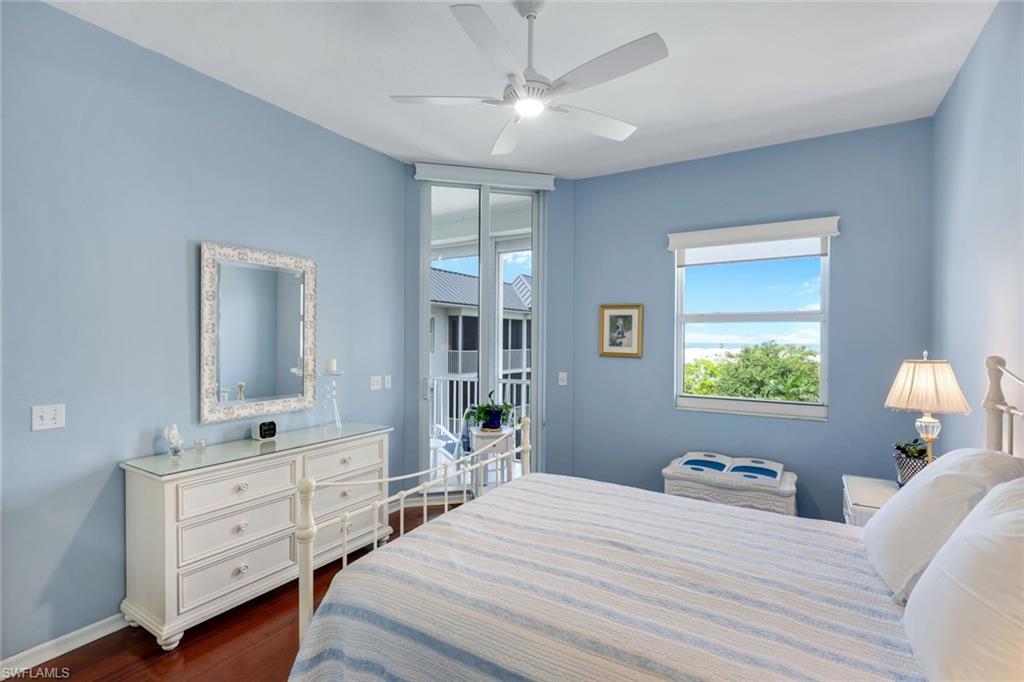460 Launch Circle, Unit PH1 Naples, FL 34108 - Photo 10 of 28 a bedroom with a bed and a dresser