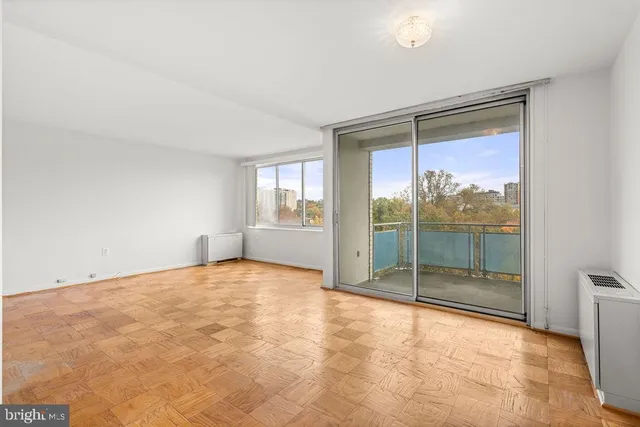 a view of an empty room with glass door