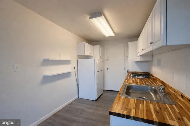 a kitchen with a refrigerator and a stove